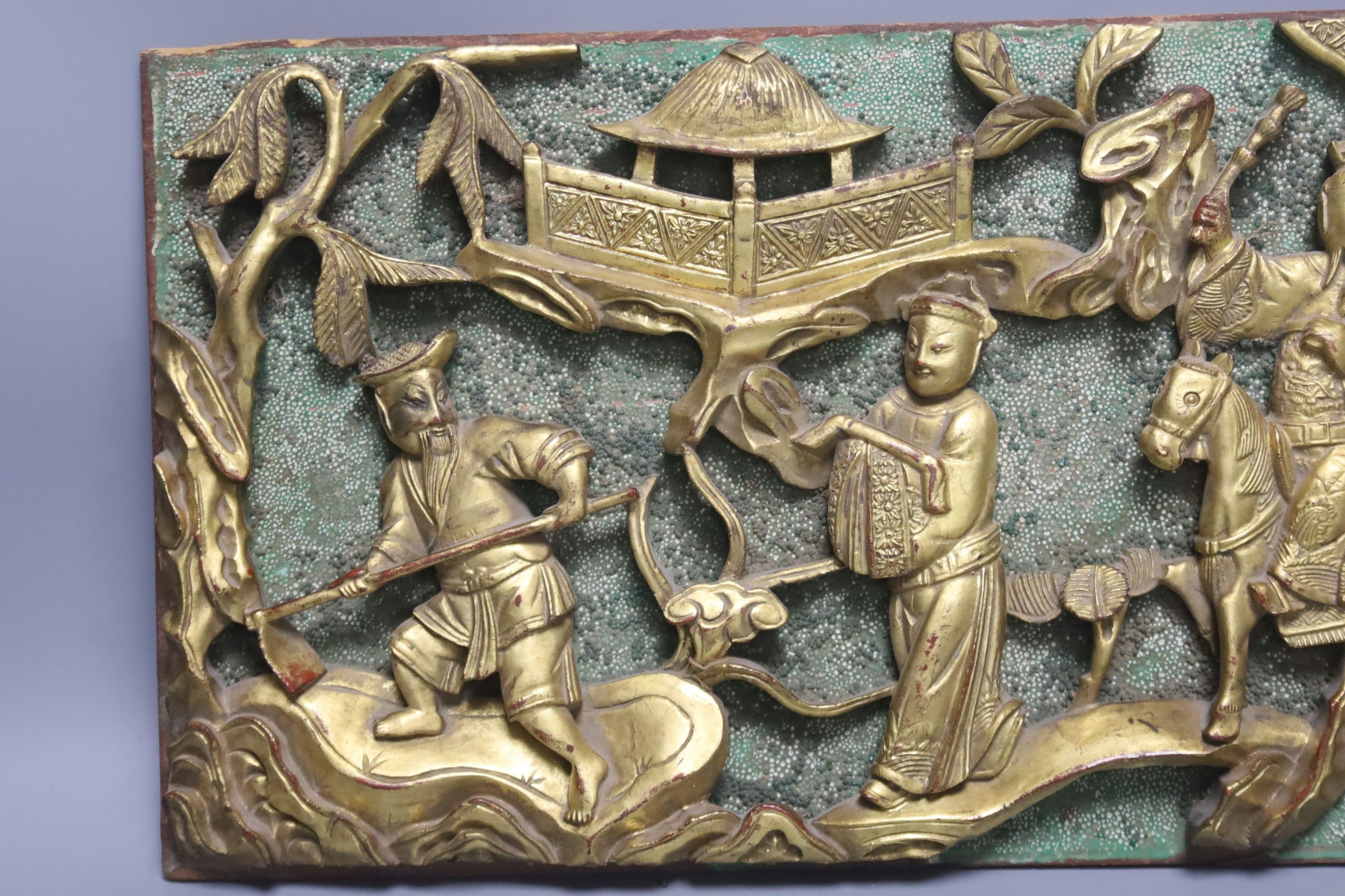 A Chinese carved giltwood plaque, 20 x 46cm